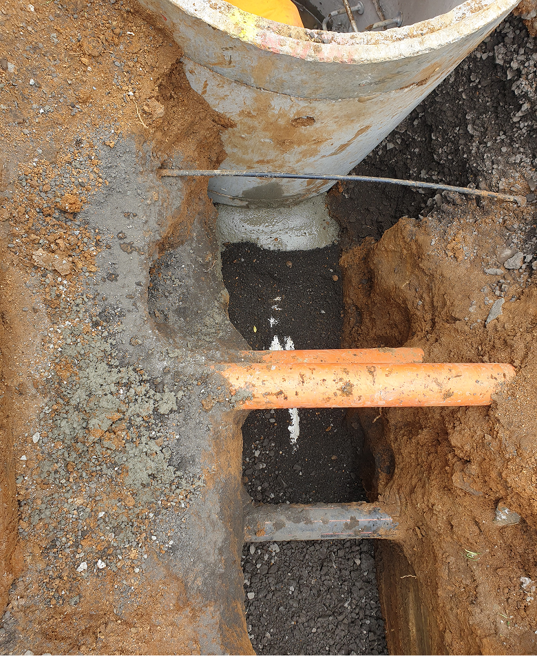 Orange drainage pipes underground.
