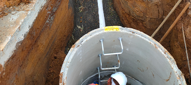 Man working inside a sewer/drain.